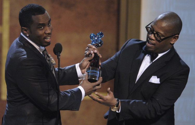 Media executive Andre Harrell, right, presents an award to Sean "Diddy" Combs at the Warner Theatre during the 2010 BET Hip Hop Honors in Washington. 