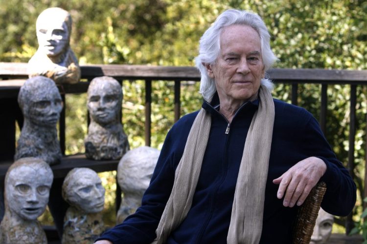 In this Sept. 16, 2010, file photo, beat poet Michael McClure is seen on his deck with sculptures by his wife, artist Amy Evans McClure, at their home in Oakland, Calif. 