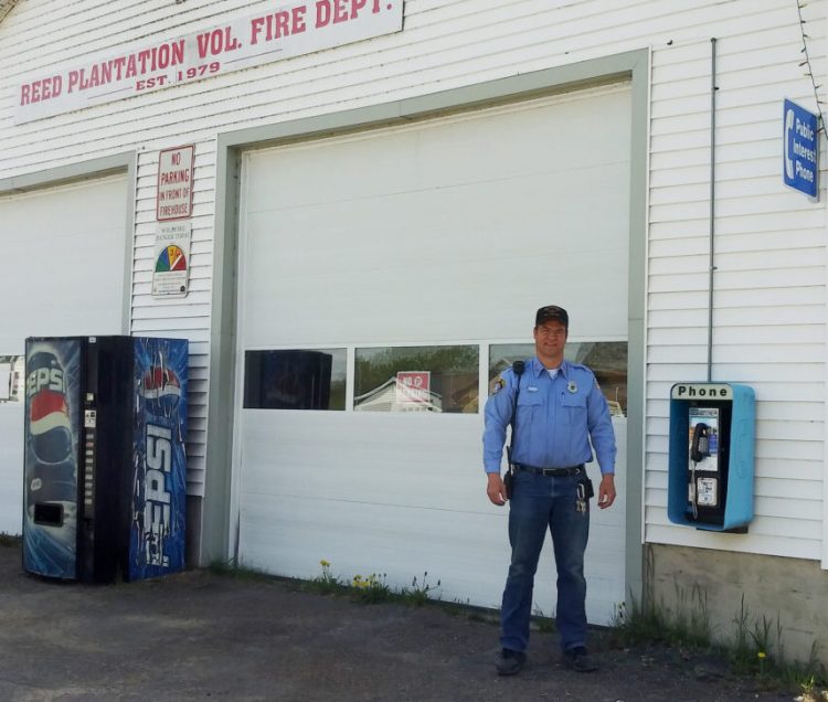 Steve Waite, a fire warden in Reed Plantation, stands by the fire station and the soon-to-be-disconnected public interest payphone. The town wants to replace the payphone, which Waite says he's never seen anyone use, with a vending machine for snacks.
