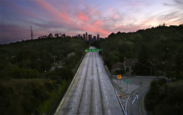 Empty lanes of the 110 Arroyo Seco Parkway that leads to downtown Los Angeles are seen in April during the coronavirus outbreak in Los Angeles, Calif. The world cut its daily carbon dioxide emissions by 17% at the peak of the pandemic shutdown last month, a new study found. 
