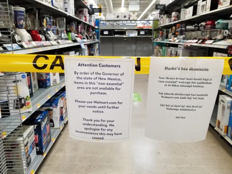 Signs inside the Walmart in Gallup, N.M., to advise shoppers that non-essential items aren't available for purchase on Friday.