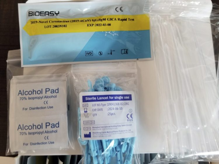 This image provided by the U.S. Immigration and Customs Enforcement shows unapproved COVID-19 tests that were seized on March 22 from the DHL Express Consignment Facility at JFK Airport in New York. Federal officials say the COVID-19 outbreak has unleashed a wave of fraud.