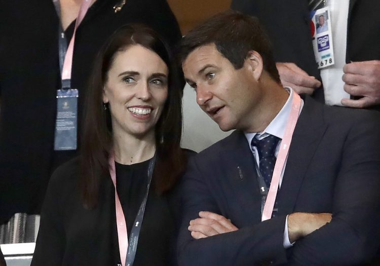 New Zealand Prime Minister Jacinda Ardern, left, stands with her fiance Clarke Gayford as they watch rugby Sept. 21 in Yokohama, Japan. 