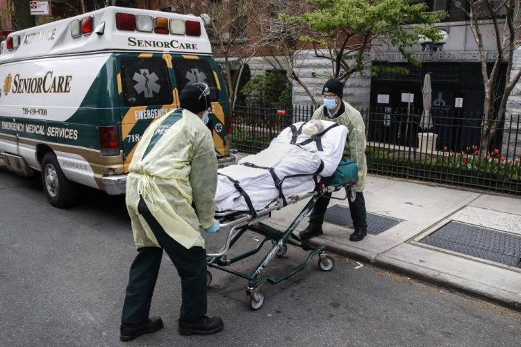 A patient is loaded into the back of an ambulance by emergency medical workers outside Cobble Hill Health Center on April 17 in the Brooklyn borough of New York. The despair wrought on nursing homes by the coronavirus was laid bare Friday in a state survey identifying numerous New York facilities where multiple patients have died. Nineteen of the state's nursing homes have each had at least 20 deaths linked to the pandemic. Cobble Hill Health Center was listed as having 55 deaths.