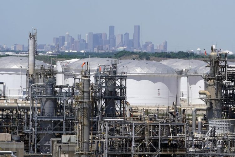 Storage tanks at a refinery along the Houston Ship Channel are seen with downtown Houston in the background. Oil extraction and mining businesses had the best success in getting loans from the Paycheck Protection Program, according to a census survey.