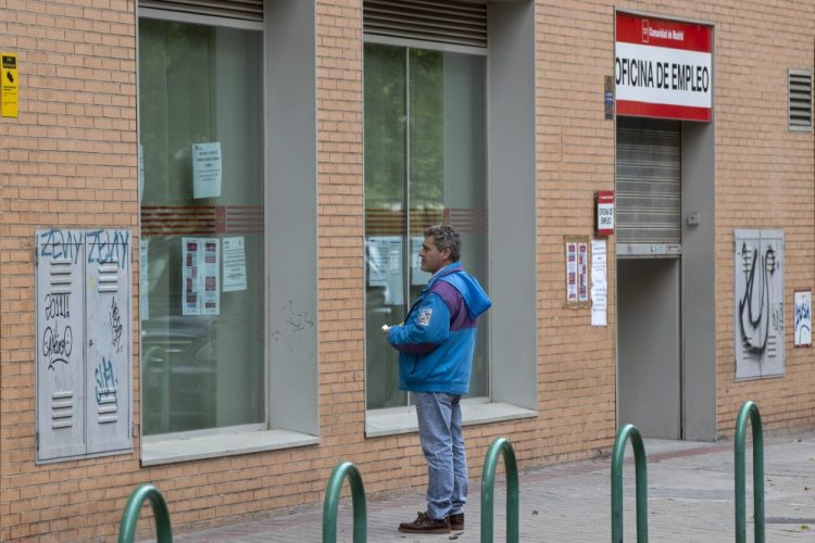 Aa man looks at notices on the window of an unemployment office April 28 in Madrid, Spain.