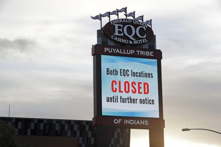 A sign indicates that the new Emerald Queen Casino in Tacoma, Wash., which is owned by the Puyallup Tribe of Indians, is closed. Hundreds of tribal casinos across the country have voluntarily closed because of the pandemic, in many cases taking away a tribe's primary source of revenue used to operate tribal government and social programs. 