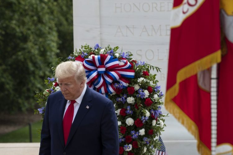 President Trump turns after saluting the Tomb of the Unknown Soldier on Monday in Arlington National Cemetery. 