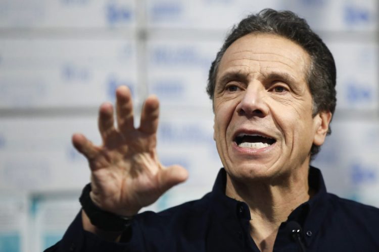New York Gov. Andrew Cuomo speaks during a news conference March 24 against a backdrop of medical supplies at the Jacob Javits Center.
