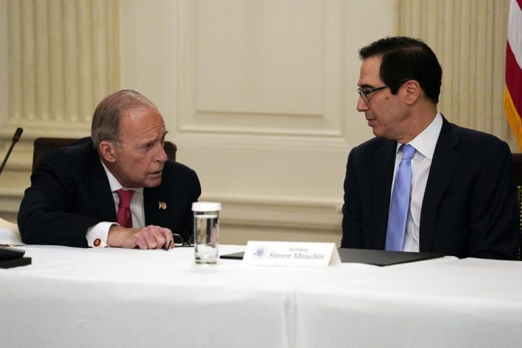 Treasury Secretary Steven Mnuchin, right, talks with White House chief economic adviser Larry Kudlow prior to a meeting Friday between President Trump and Republican lawmakers in the State Dining Room of the White House in Washington.