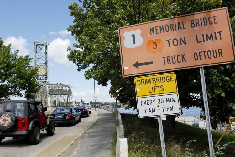 Vehicles wait to cross Memorial Bridge in New Hampshire where the bridge is posted as having a 3 Ton Limit on July 22, 2010.