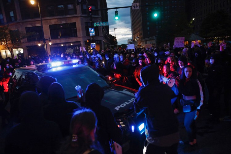 Protesters surround a Portland police cruiser on the night of June 1 as a protest that drew an estimated 2,500 people gets tense.