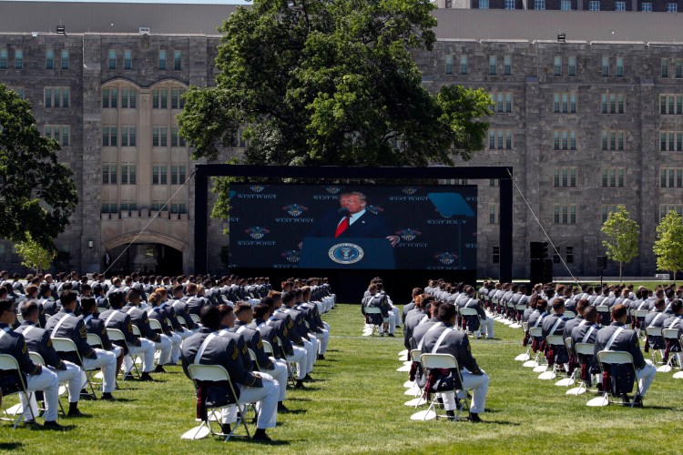 A screen displays President Trump as he speaks to over 1,110 cadets in the class of 2020 at a commencement ceremony on the parade field at the U.S. Military Academy in West Point, N.Y., on Saturday. 