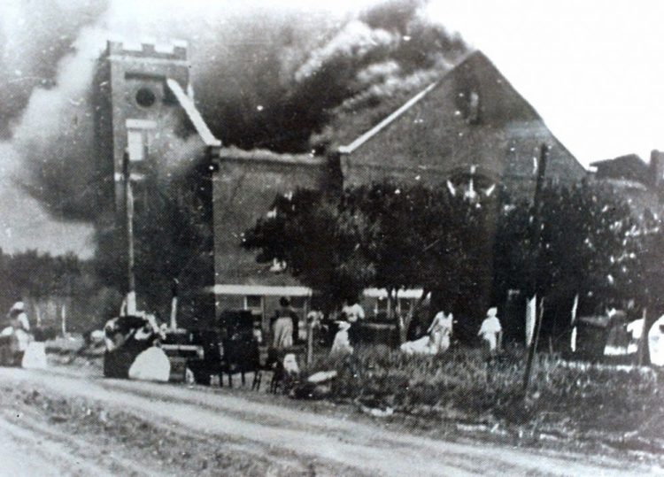 Mt. Zion Baptist Church burns after being torched by white mobs during the 1921 Tulsa massacre. Black community and political leaders called on President Trump to at least change the Juneteenth date for a rally kicking off his return to public campaigning.