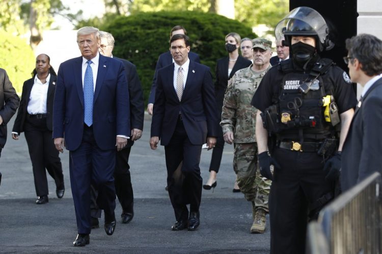 President Trump, followed by Defense Secretary Mark Esper, leaves the White House on Monday to visit outside St. John's Church in Washington, after having protesters cleared from nearby Lafayette Park.