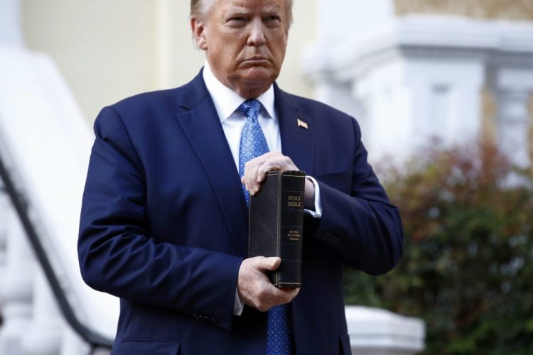 President Trump holds a Bible as he visits outside St. John's Church across Lafayette Park from the White House on Monday. 