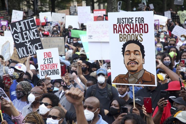 A crowd of demonstrators march to the Capitol on Monday in Atlanta. Rayshard Brooks, 27, was shot and killed by police Friday night. 