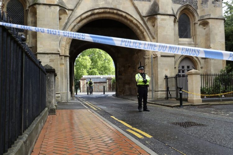 Police stand guard at the Abbey gateway of Forbury Gardens park in Reading following Saturday's stabbing attack in the gardens. Thames Valley Police said a 25-year-old man from the town has been arrested and they are not looking for anyone else.  