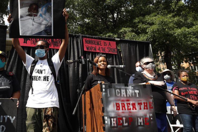 Maisie Brown, 18, center, a member of the Mississippi branch of Black Lives Matter, speaks during a rally June 6 protesting police brutality in Jackson, Miss. Young activists like Brown are energizing the debate about removing the Confederate battle emblem from the Mississippi state flag. 
