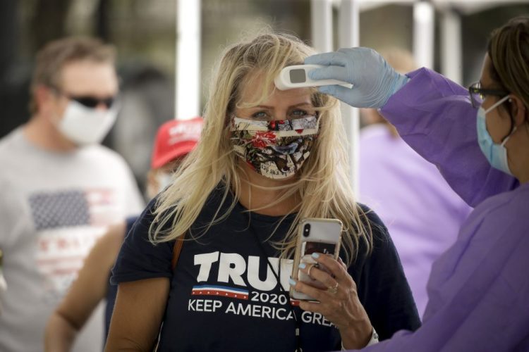 A supporter gets her temperature checked prior to attending a campaign rally for President Trump at the BOK Center in Tulsa, Okla., on Saturday.