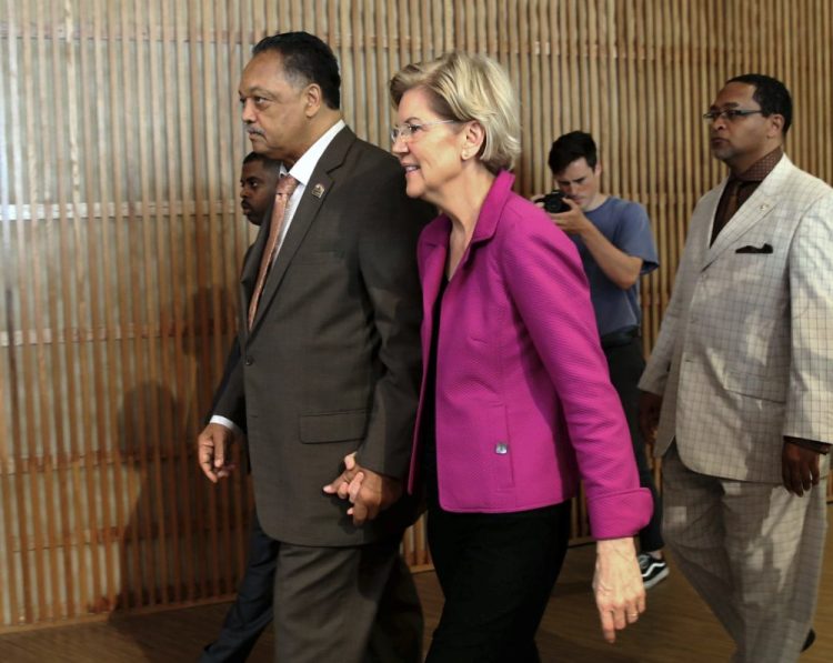 The Rev. Jesse Jackson walks with Sen. Elizabeth Warren, D-Mass., in June 2019. (Kevin Tanaka/Chicago Sun-Times via AP, File)