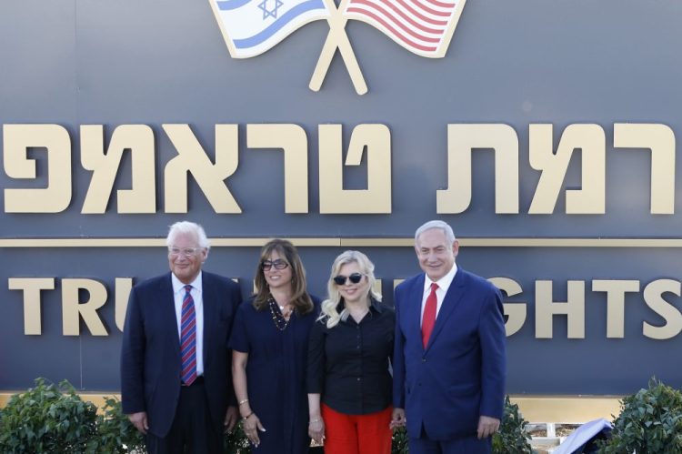 Israeli Prime Minister Benjamin Netanyahu, right, his wife Sara, United States Ambassador to Israel David Friedman, left, and his wife Tammy  during the inauguration of a new settlement named after President Trump in the Golan Heights, on June 16, 2019. An Israeli cabinet minister said the government approved the settlement plans. 