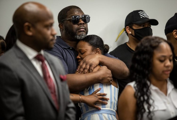 Family members of Rayshard Brooks attend a news conference on Monday in Atlanta. Tomika Miller, Brooks' widow, asked those demonstrating to “keep the protesting peaceful,” saying: “We want to keep his name positive and great.”