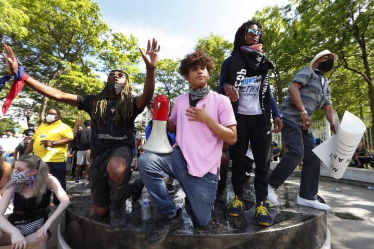 Stefan Perez, second from left, addresses a crowd at a rally June 3 in Detroit over the death of George Floyd. 
