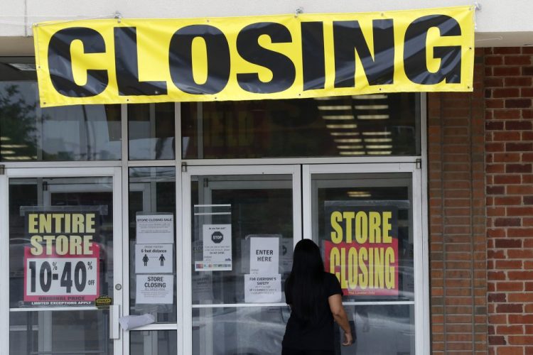A woman walks into a closing Gordmans store on May 28 in St. Charles, Mo. In the U.S., states have begun reopening their economies, thereby allowing businesses to recall some employees to work. But economic activity is returning only very gradually. 