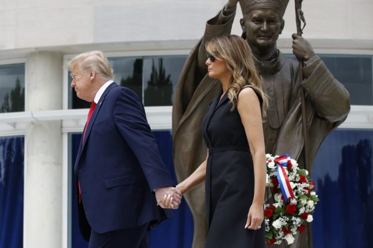 President Trump and first lady Melania Trump depart after visiting Saint John Paul II National Shrine on Tuesday in Washington. 
