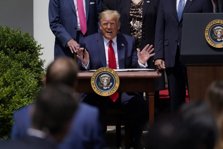 President Donald Trump speaks as he signs the Paycheck Protection Program Flexibility Act during a news conference in the Rose Garden of the White House, on Friday in Washington.