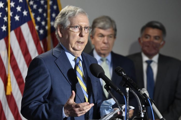 Senate Majority Leader Mitch McConnell of Ky., speaks to reporters after the weekly Republican policy luncheon on Wednesday. Sen. Roy Blunt, R-Mo., center, and Sen. Cory Gardner, R-Colo., right, listen. 