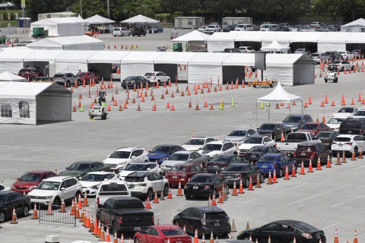 Lines of cars wait at a coronavirus testing site outside of Hard Rock Stadium on Friday in Miami Gardens, Fla.