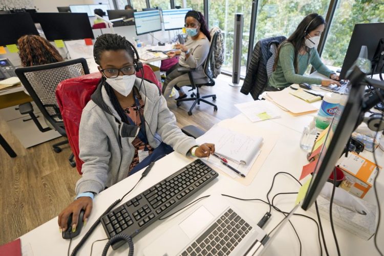 Contact tracers, from left to right, Christella Uwera, Dishell Freeman and Alejandra Camarillo work at Harris County Public Health contact tracing facility on Thursday in Houston. On Monday, the U.S. reported 38,800 newly confirmed infections, with the total surpassing 2.5 million, according to a tally by Johns Hopkins University.