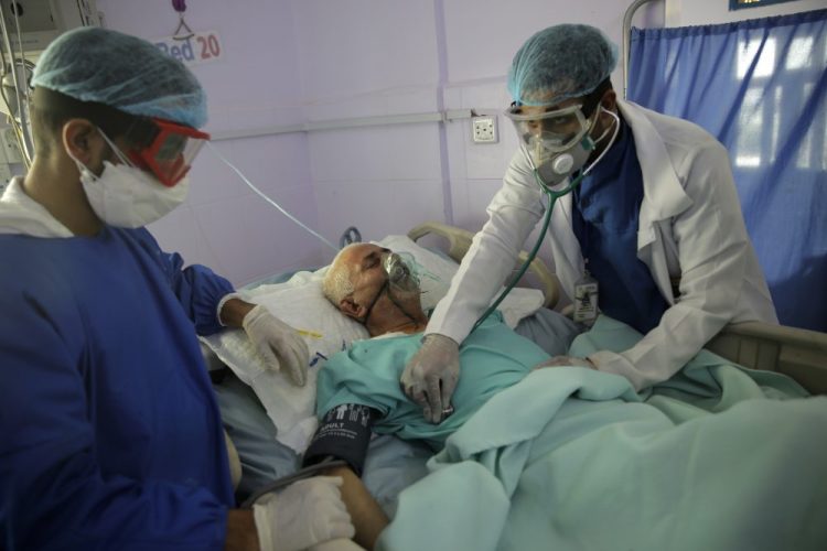 Medical workers attend to a COVID-19 patient in an intensive care unit at a hospital in Sanaa, Yemen, on Sunday. Researchers in England say they have the first evidence that dexamethasone reduced deaths by up to one third in severely ill hospitalized patients. 