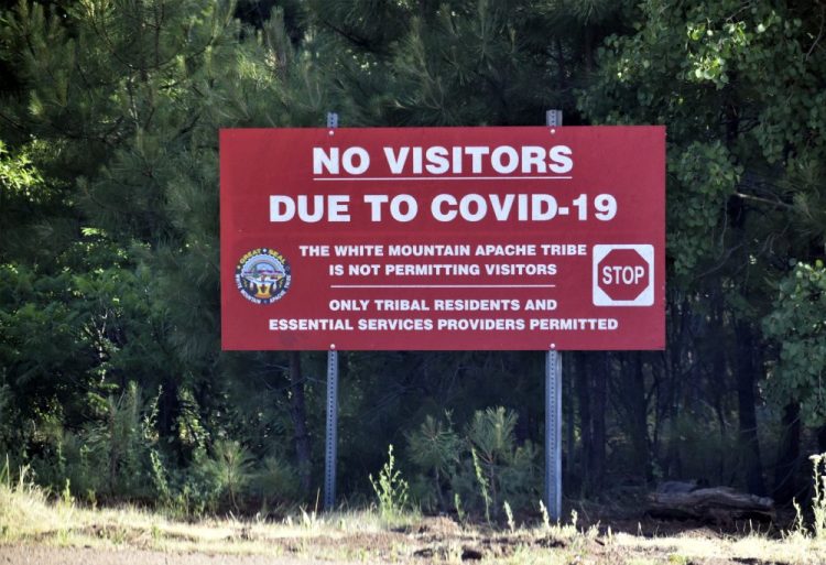 A sign alerts motorists that visitors are not allowed on the Fort Apache Indian Reservation in eastern Arizona. The reservation, home to the White Mountain Apache Tribe, will be under lockdown this weekend to help slow the spread of the coronavirus. 