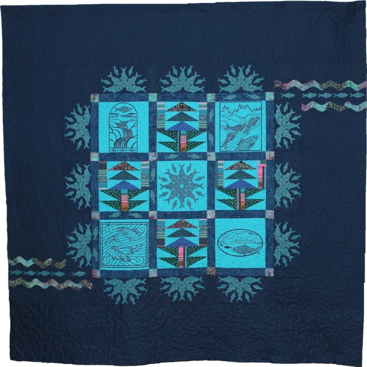 The Damariscotta Mills Alewife Festival Quilt was pieced by Betty Lu Brydges and machine quilted by Lynn Vogt. It includes silk screened designs drawn by local artists for festival goods and gear imprints in previous years. 