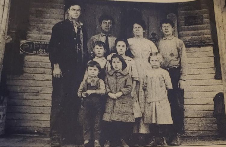 Rosalie Colby's grandmother Grace Lockin is the oldest girl in the center of this family portrait taken in front of the grocery store her father ran out of their home in Brownfield, circa 1914. The Maine Sunday Telegram wrote about Grace Lockin in 1933, and  her recipe for potato fudge appears in the "Maine Bicentennial Cookbook."