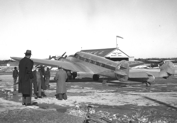 A Boston-Maine airplane at the Portland Municipal Airport in 1941. The hanger in the background shows the company's new name as of 1940: Northeast Airlines in 1940 and eventually Delta Airlines.