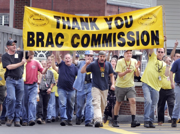 Workers from the Portsmouth Naval Shipyard walk through gate 1 cheering the BRAC Commission's decision to keep the shipyard open in August 2005.

