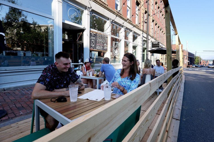 Diners enjoy a newly set-up outdoor dining area, dubbed Camp Hunt + Alpine, on Market Street in the Old Port. 