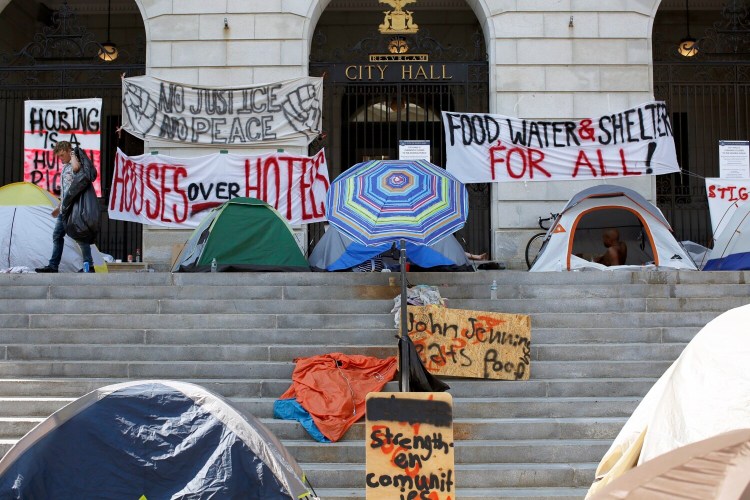 Tents and protest signs line the top of the steps at Portland City Hall as the so-called "sleep out" enters another night. 