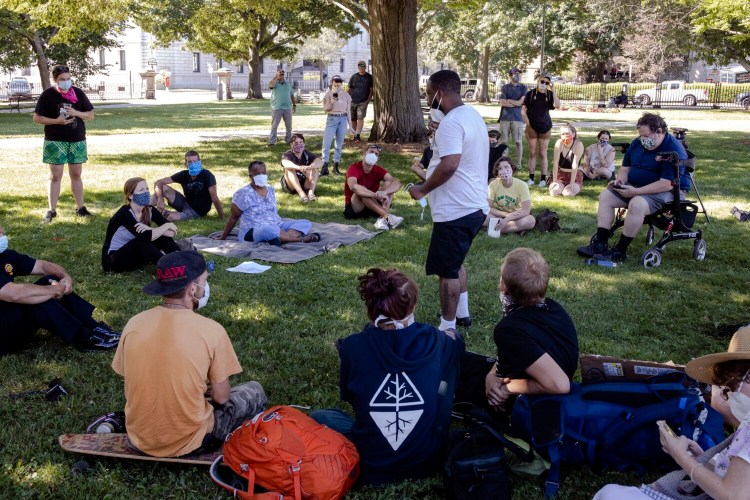 Joshua Rezendez tells his story to city officials during a listening session at Lincoln Park on Wednesday, July 29, 2020. The meeting, attended by Mayor Kate Snyder, Fire Chief Keith Gautreau, and city councilors Spencer Thibodeau and Jill Duson, was held to hear out the organizers, participants and allies who are holding the tent-out outside of City Hall. 