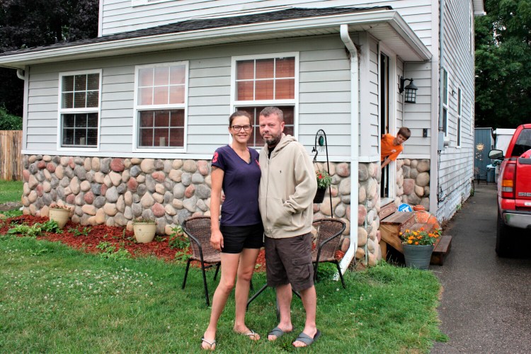 Crystal and Chris Martin at their home, in Burton, Mich. The Martins, who had to defer some mortgage payments, are among millions of Americans who have struggled financially during the coronavirus pandemic. Crystal was laid off in March from her job and Chris, an X-ray technician at a Flint hospital, was also laid off. 