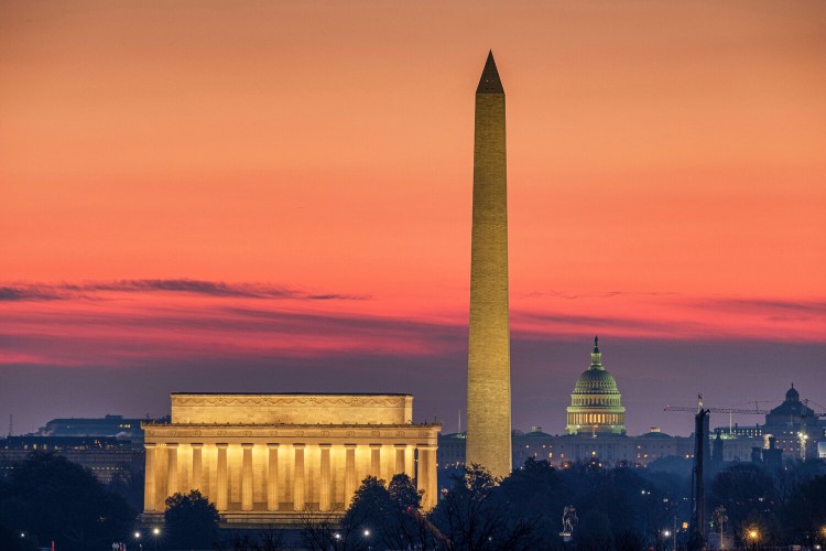The Lincoln Memorial, left, and the Washington Monument, center, are seen in the early-morning light in February in Washington. The U.S. Capitol building is in the background right. Senate Republicans released a plan Monday that would cut the weekly jobless benefit to $200 per week while states work on a complicated system that would replace 70 percent of people’s wages.