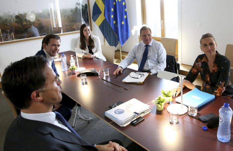 From left, Dutch Prime Minister Mark Rutte, Austria's Chancellor Sebastian Kurz, Finland's Prime Minister Sanna Marin, Sweden's Prime Minister Stefan Lofven and Denmark's Prime Minister Mette Frederiksen meet on the sidelines of an EU summit at the European Council building in Brussels on Sunday. 