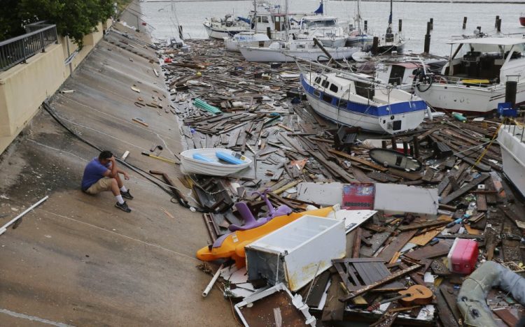 Allen Heath surveys the damage to a private marina after it was hit by Hurricane Hanna on Sunday in Corpus Christi, Texas. Heath's boat and about 30 others were lost or damaged. 