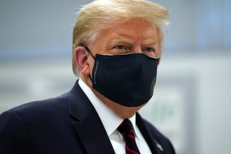 President Trump wears a face mask for the second time in public as he tours the Bioprocess Innovation Center at Fujifilm Diosynth Biotechnologies on Monday in Morrisville, N.C. In addition to sharing the video, Trump retweeted several tweets that attacked the credibility of Dr. Fauci, a leading member of the White House coronavirus task force. 