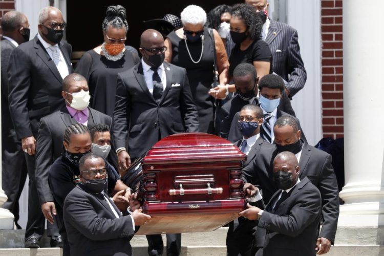 The casket containing the remains of Rev. C.T. Vivian are carried from Providence Missionary Baptist Church after a funeral service Thursday in Atlanta.