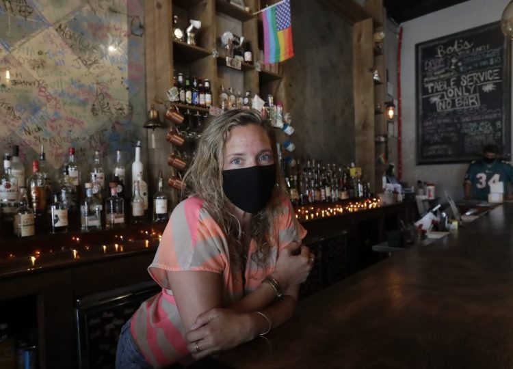 Danielle Savin, co-owner of a bar called Bob's Your Uncle, poses for a photo June 30 at the bar in Miami Beach, Fla. Savin owns two bars that were forced to shut down for months in both New York and Miami Beach.